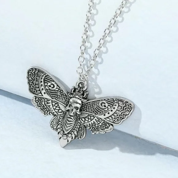 Skull moth earrings representing resilience - Picture 5 of 5